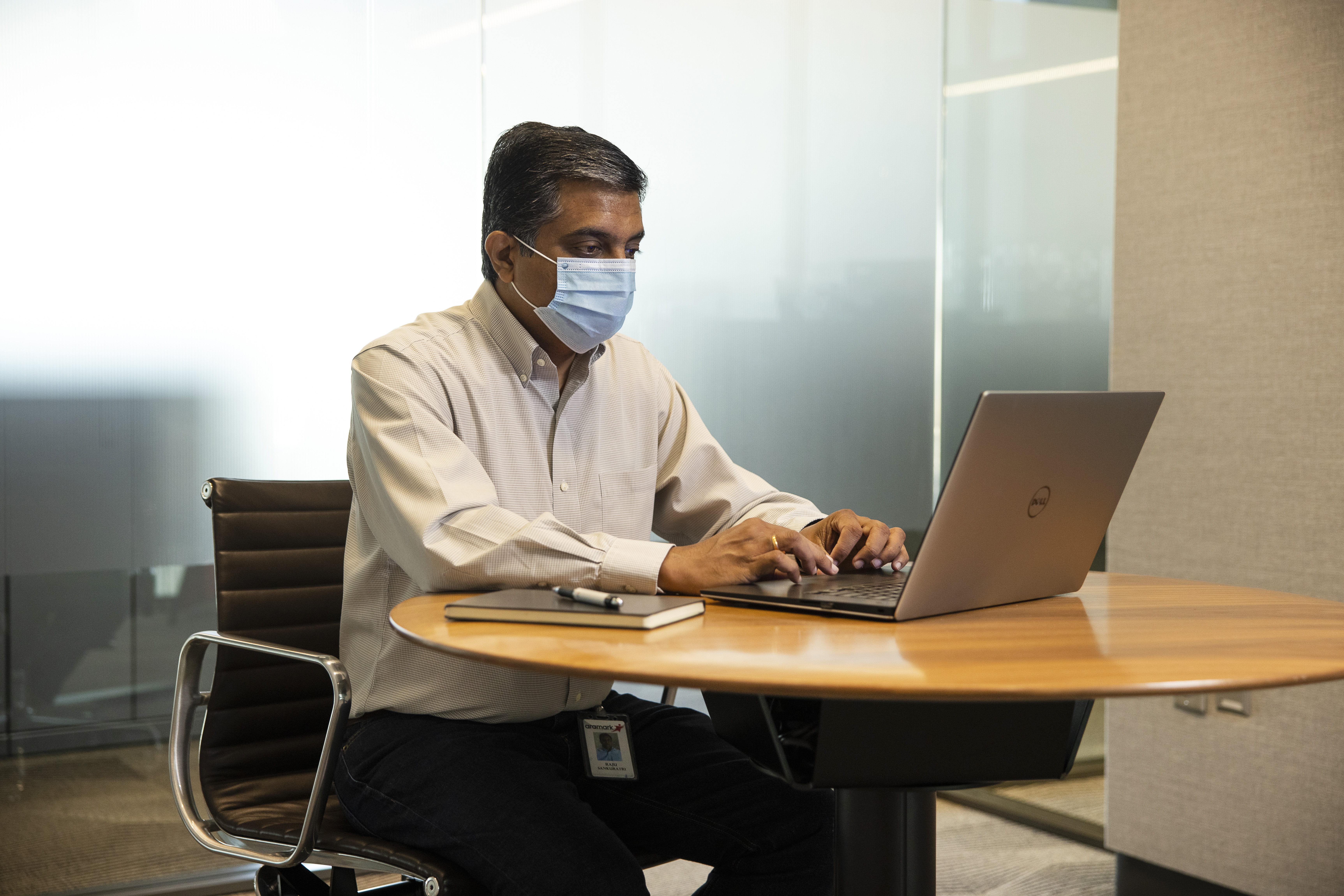 Man in mask on a laptop